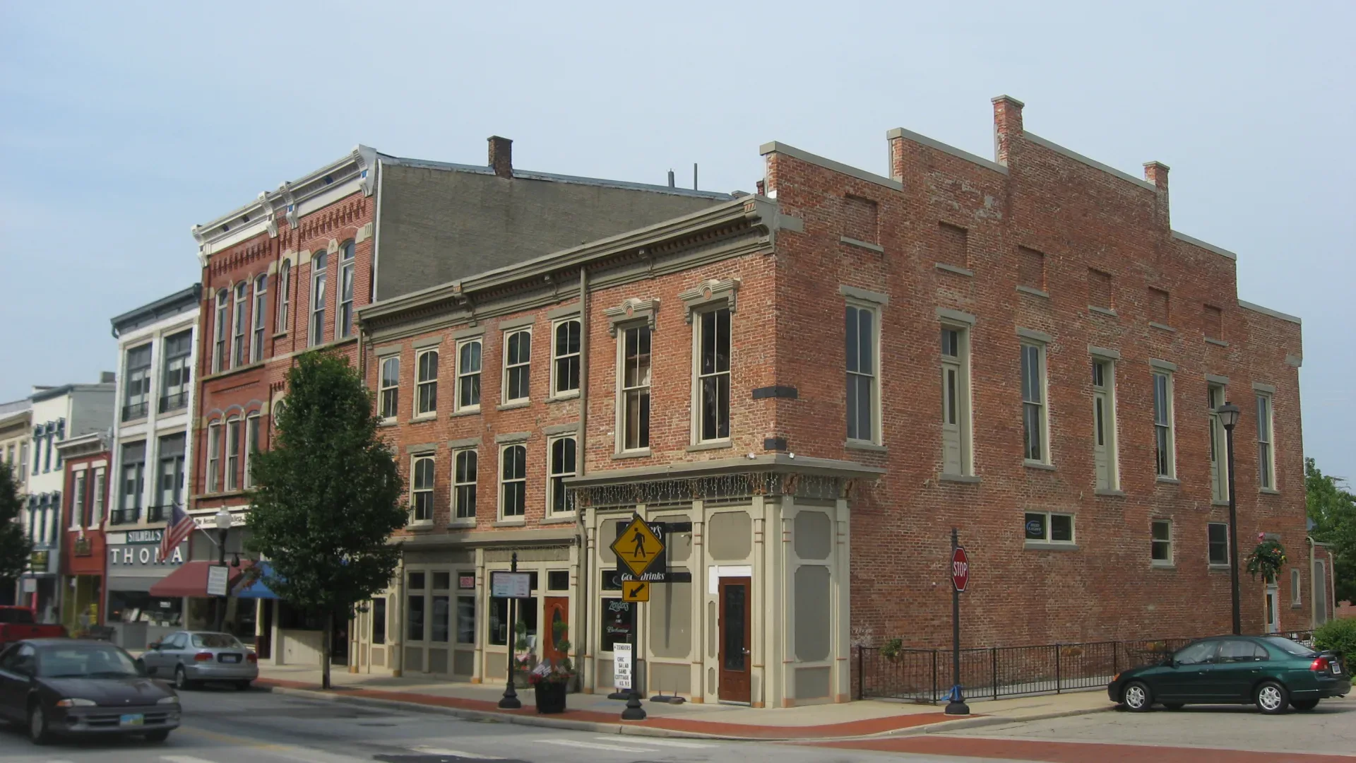 A historic brick corner building on North Main Street in downtown Piqua, Ohio
